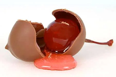 A chocolate covered cherry broken open