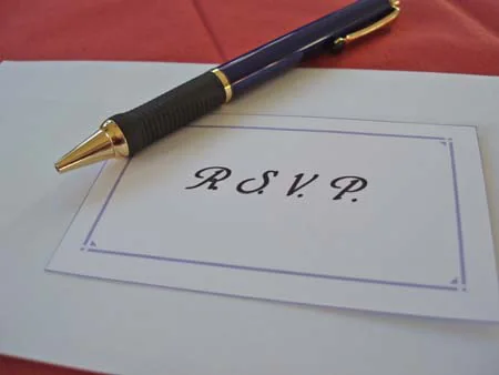 A pen resting on an RSVP card