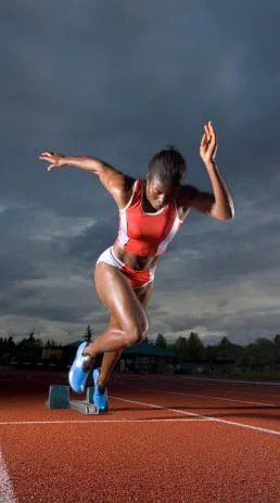 A sprinter exploding out of the starting blocks on a track
