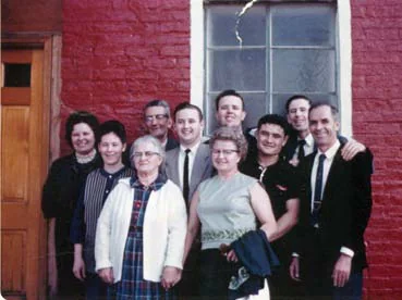 The Johnson family gathered outside a red brick church