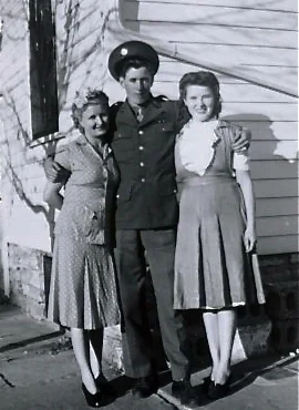 A young Walker Johnson in uniform standing with family