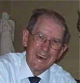 Uncle Walker laughing, dressed in a white shirt and tie
