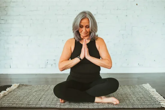 Joanna in a peaceful prayer pose